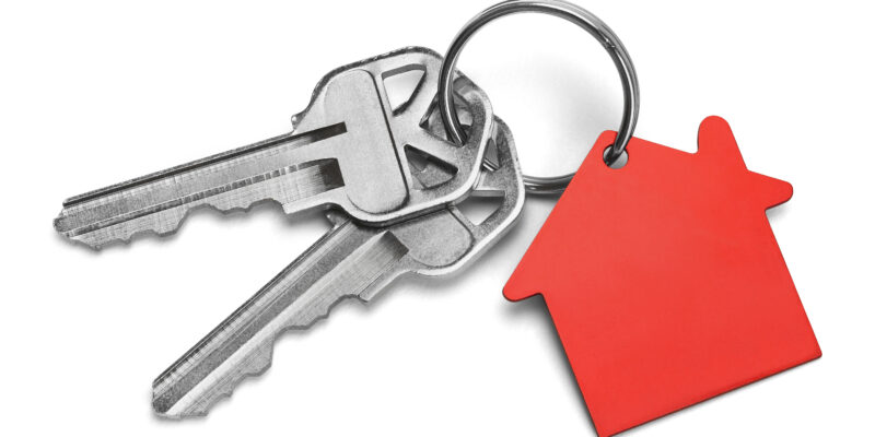 Set of Keys With Red House Isolated on White Background.