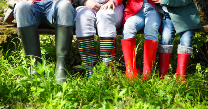 Happy family wearing colorful rain boots. Family concept