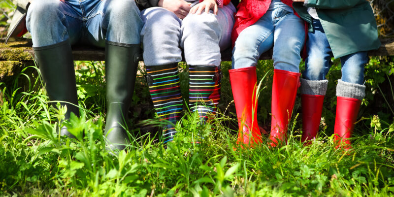 Happy family wearing colorful rain boots. Family concept