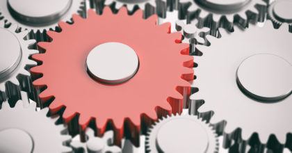 One red metal gear on silver wheelgears background. 3d illustration