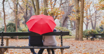 couple under umbrella in autumn park, love concept, happy elderly people