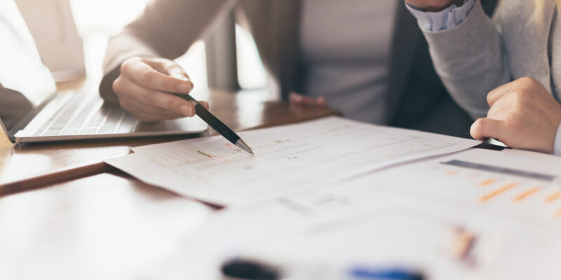 business working with woman and friend with laptop and paperwork with color tone effect