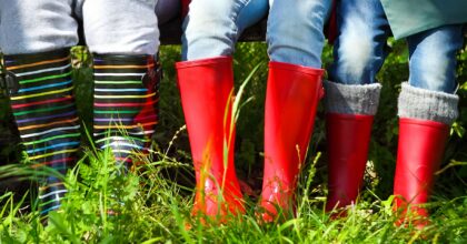 Happy family wearing colorful rain boots