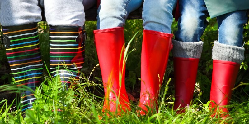 Happy family wearing colorful rain boots